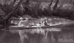 Two fishing buddies enjoy catching a rainbow trout from a canoe near the I-40 rest stop on the Caney Fork River