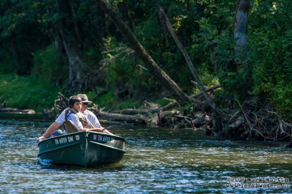 A Father instructs his son while fishing for trout near Sebowisha on the Caney Fork River